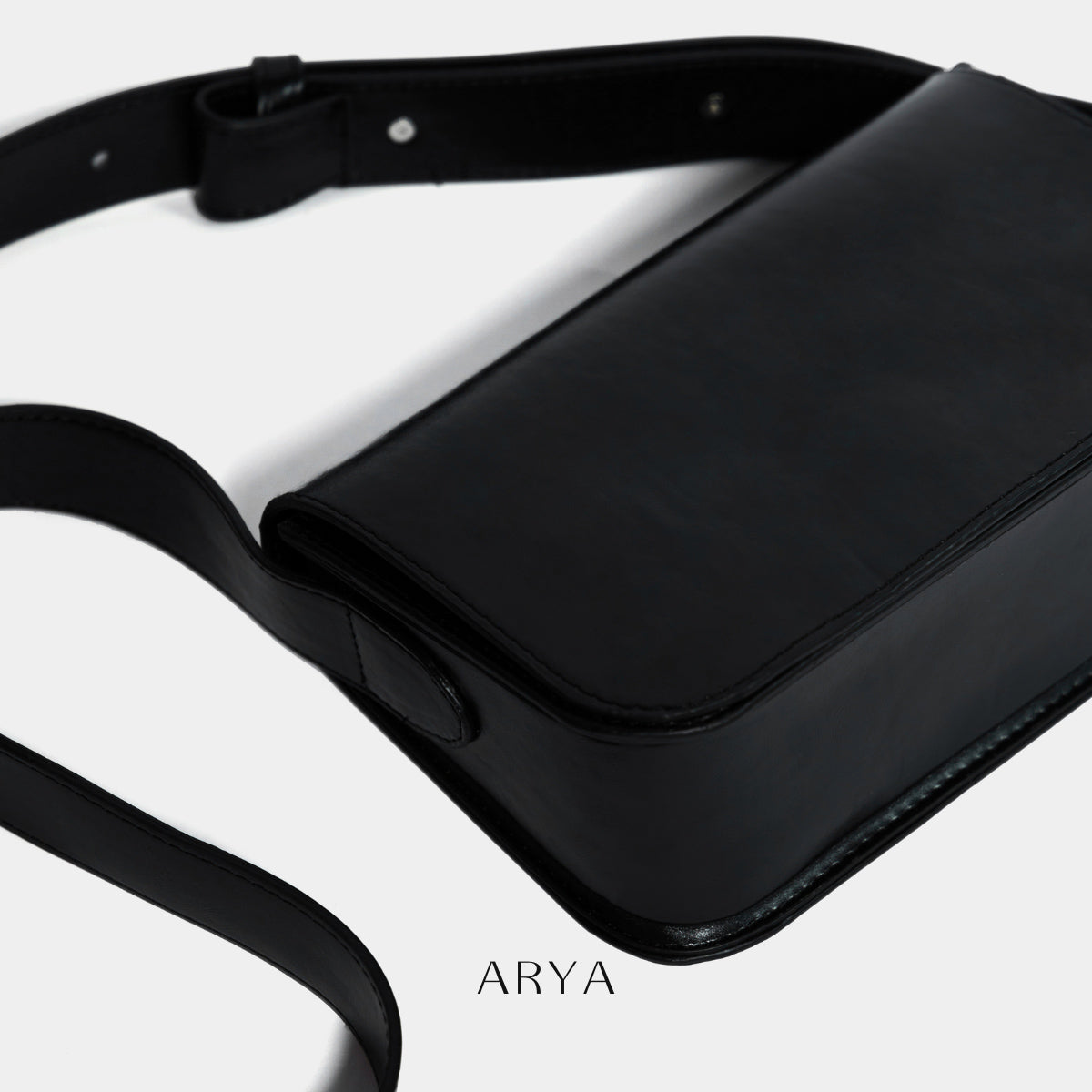 BLACK DAILY FLAP BAG by ARYA in synthetic microfiber leather, dimensions 8.66 x 5.51 x 3.15 inches, available at ASTOUD.